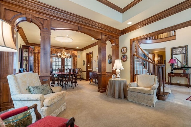 living area featuring crown molding, stairs, carpet flooring, arched walkways, and ornate columns