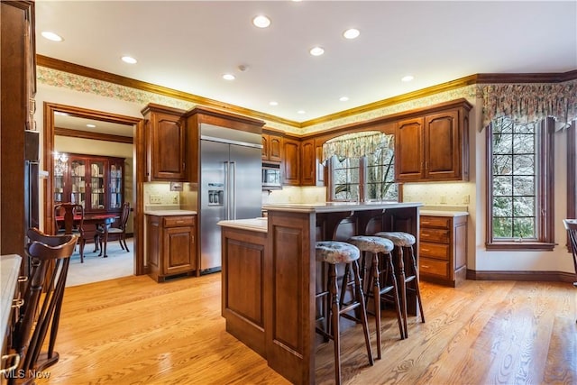 kitchen with a wealth of natural light, stainless steel appliances, and light countertops