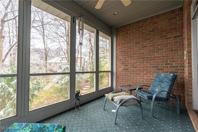 unfurnished sunroom with ceiling fan