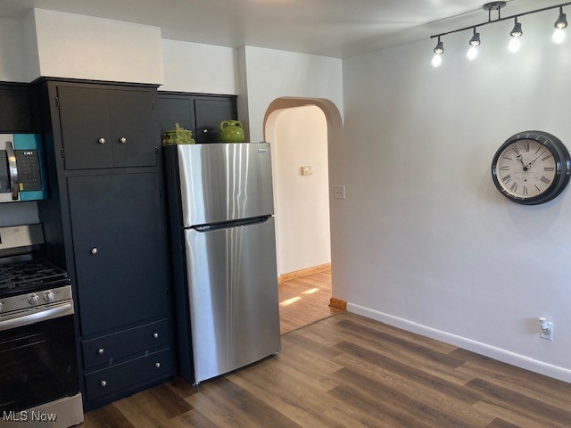 kitchen featuring dark wood-type flooring and appliances with stainless steel finishes