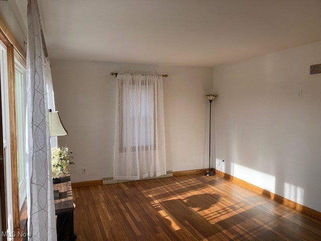 empty room with dark hardwood / wood-style floors