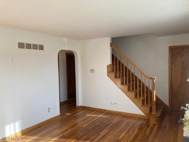 empty room with dark hardwood / wood-style flooring