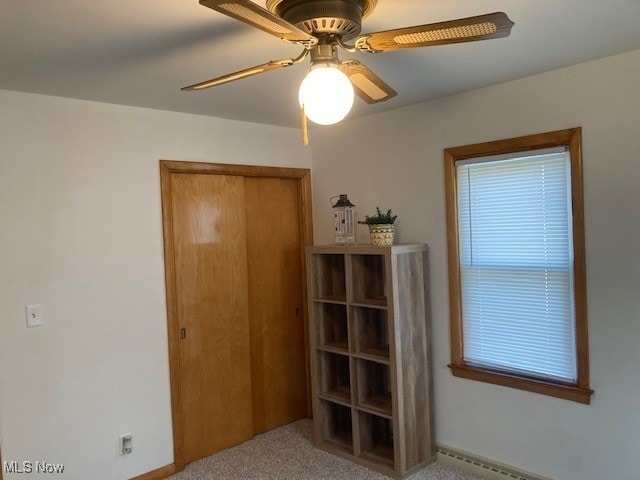 bedroom featuring ceiling fan, baseboard heating, and light carpet