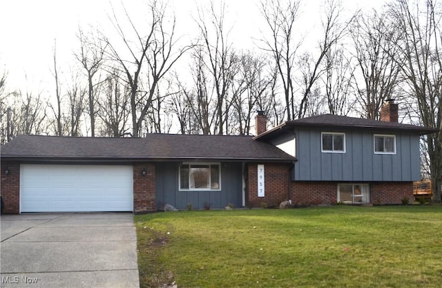 tri-level home with a garage and a front lawn