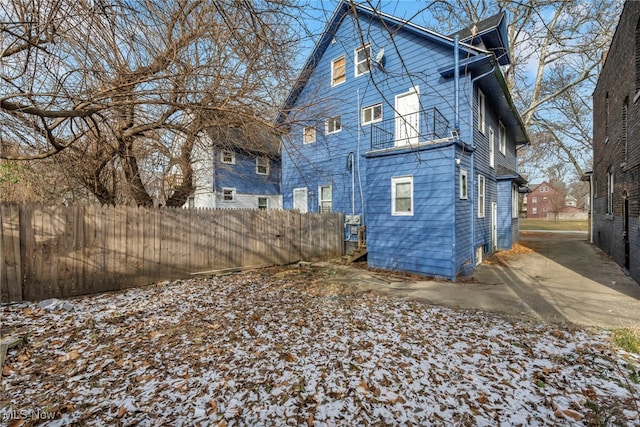 view of snow covered back of property