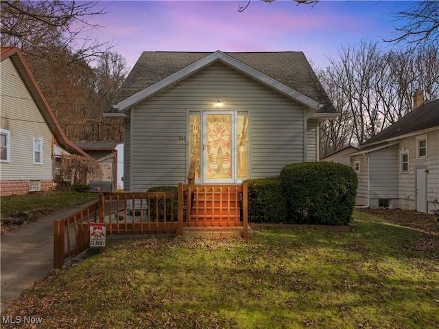 bungalow-style house with a yard