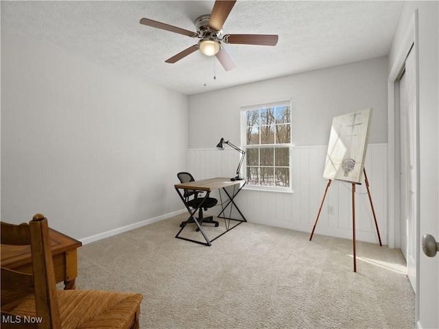 miscellaneous room with a textured ceiling, carpet floors, and ceiling fan