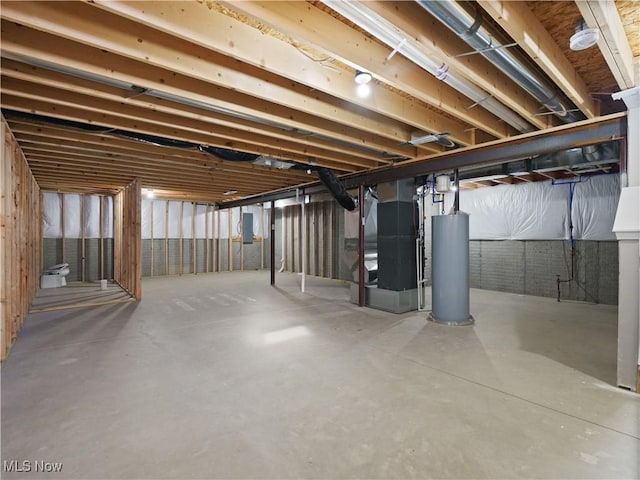 basement featuring heating unit and water heater