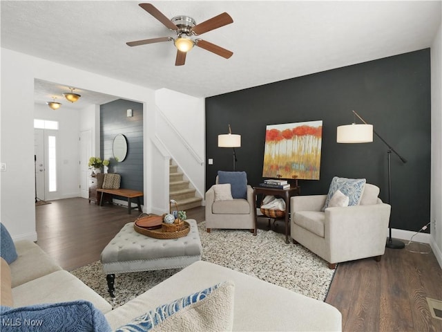 living room with ceiling fan and dark hardwood / wood-style flooring