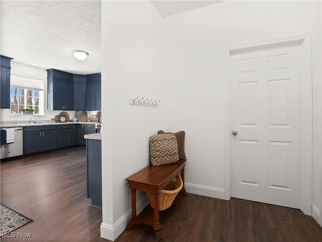 corridor featuring a textured ceiling and dark hardwood / wood-style flooring