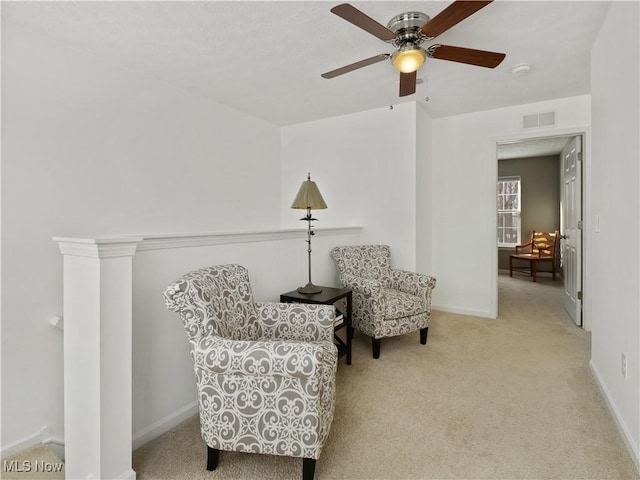 sitting room featuring ceiling fan and light colored carpet