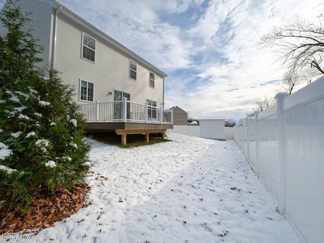 snow covered property featuring a deck