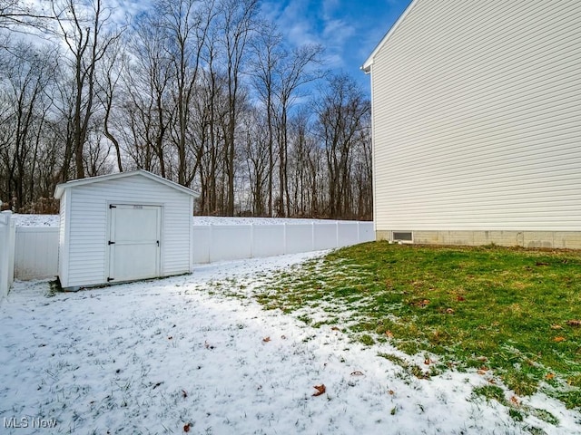 yard covered in snow featuring a shed