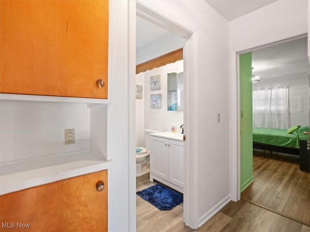 bathroom with vanity, hardwood / wood-style flooring, and toilet