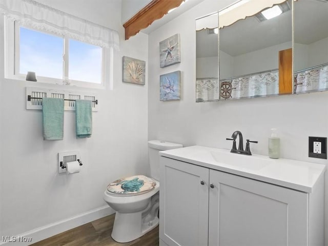 7630 Darling Ave, Conneaut, OH 44030 - full bathroom with toilet, baseboards, wood finished floors, and vanity