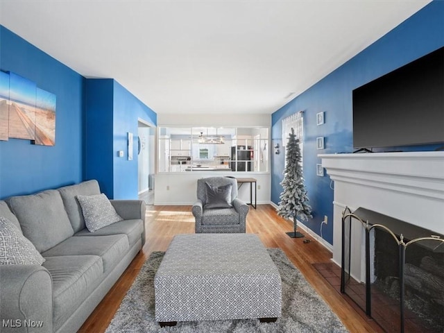 living room with ceiling fan and light wood-type flooring