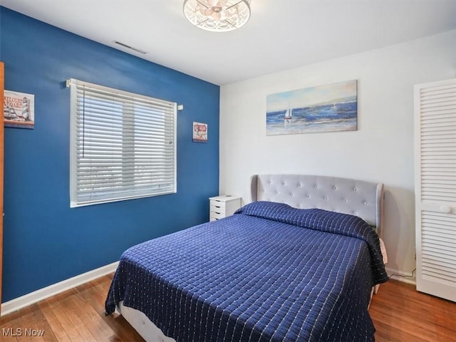 7630 Darling Ave, Conneaut, OH 44030 - bedroom with baseboards, visible vents, and wood finished floors