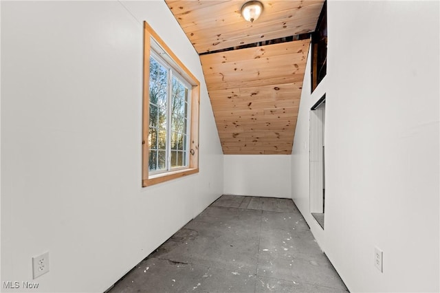 bonus room with concrete floors, vaulted ceiling, and wood ceiling