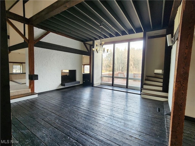 unfurnished living room with dark hardwood / wood-style flooring and a notable chandelier