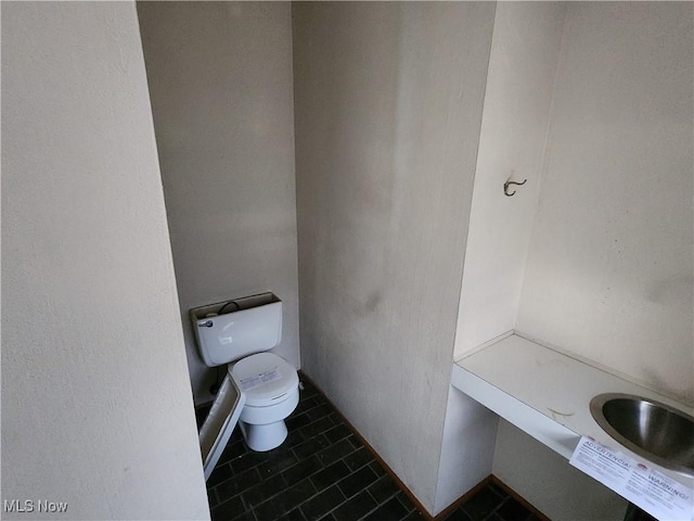 bathroom featuring tile patterned floors and toilet