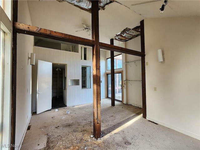 unfurnished room with high vaulted ceiling and ceiling fan