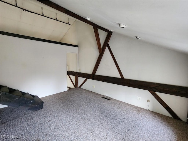 additional living space featuring carpet and lofted ceiling