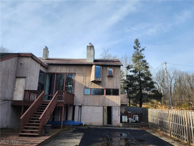 back of house featuring a deck