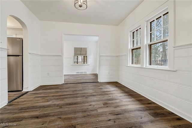 unfurnished dining area featuring dark hardwood / wood-style floors