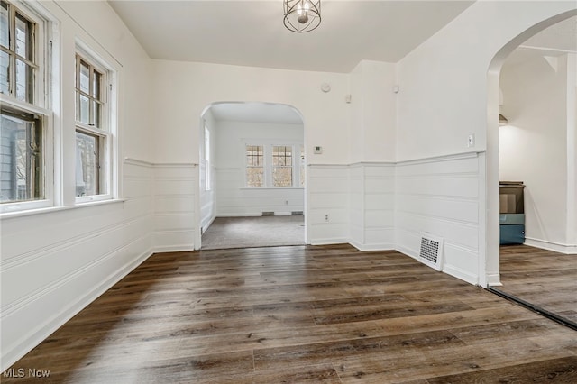 unfurnished room with dark wood-type flooring