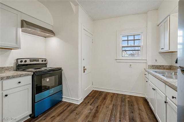 kitchen featuring stainless steel range with electric stovetop, dark wood-type flooring, sink, wall chimney range hood, and white cabinets