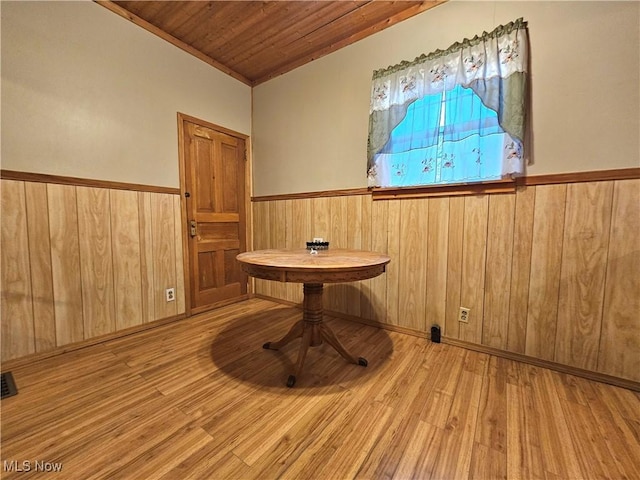 unfurnished room with wood ceiling and light wood-type flooring