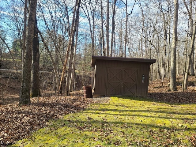 view of outbuilding featuring a lawn