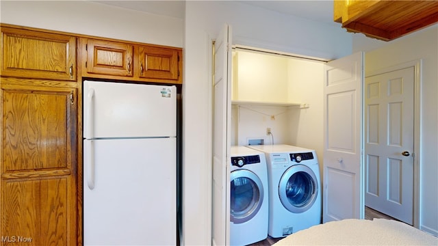 clothes washing area with independent washer and dryer