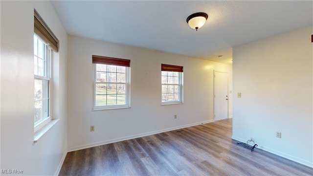 spare room with wood-type flooring