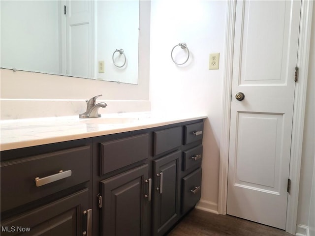 bathroom with hardwood / wood-style floors and vanity