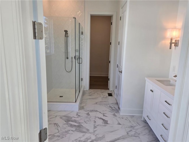 bathroom with vanity and a shower with shower door