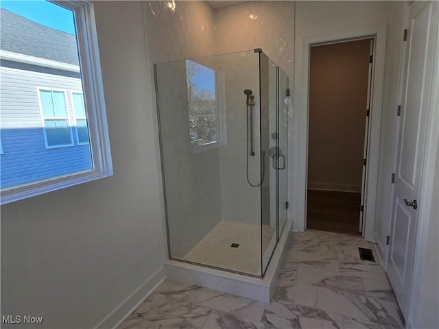 bathroom featuring a shower with shower door