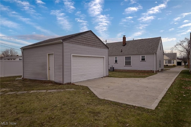 garage featuring central AC and a yard