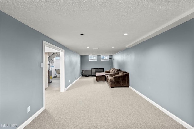 living room with a textured ceiling and light carpet