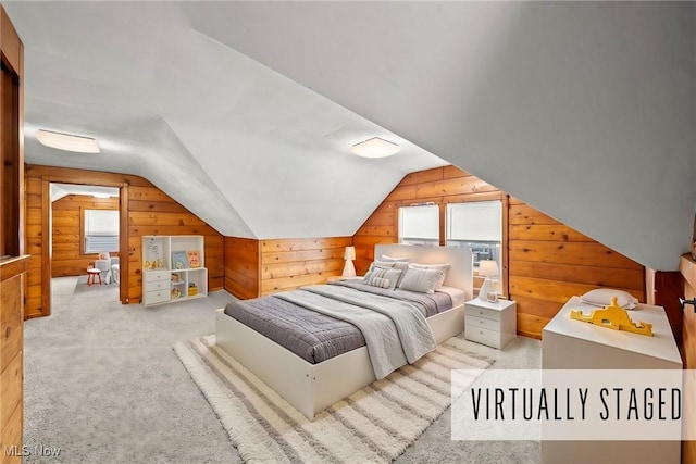 bedroom with wood walls, vaulted ceiling, light colored carpet, and multiple windows