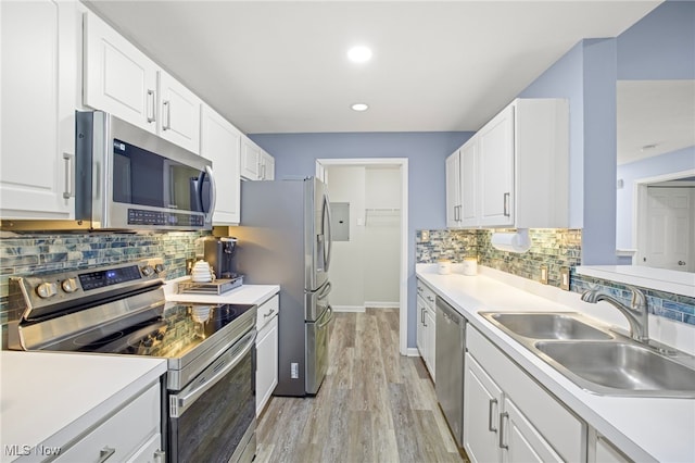 kitchen featuring white cabinetry, sink, and appliances with stainless steel finishes