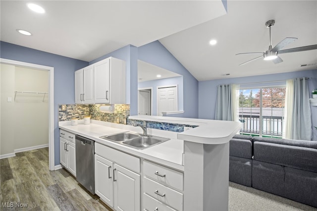 kitchen with tasteful backsplash, white cabinetry, dishwasher, and sink