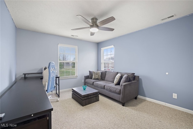 carpeted living room featuring ceiling fan