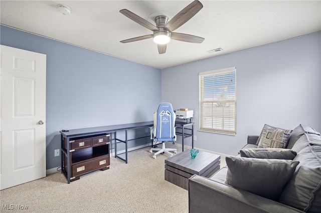 interior space featuring light carpet and ceiling fan