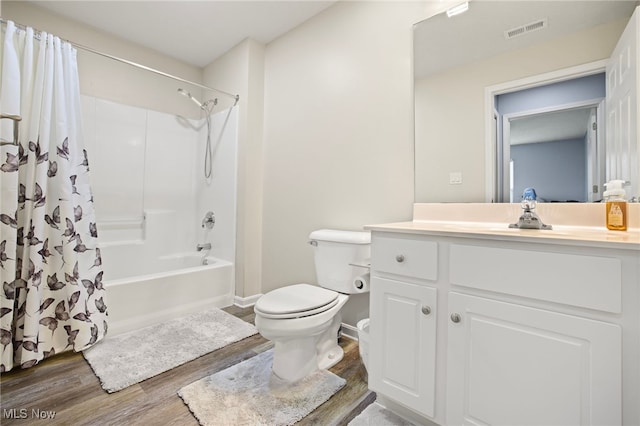 full bathroom with hardwood / wood-style floors, vanity, toilet, and shower / bathtub combination with curtain