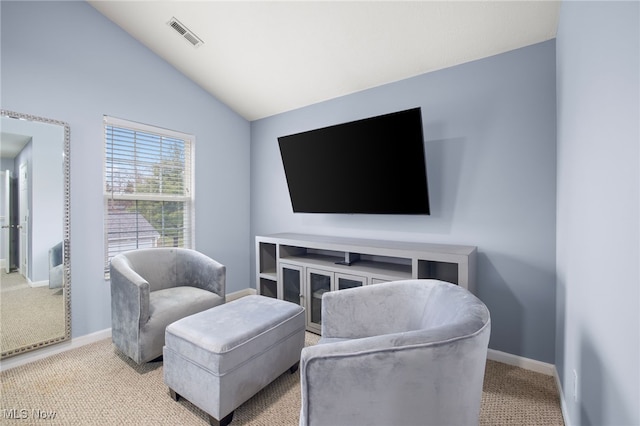 carpeted living room featuring lofted ceiling