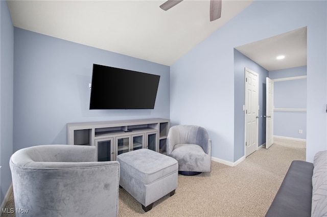 living room with carpet flooring, ceiling fan, and vaulted ceiling