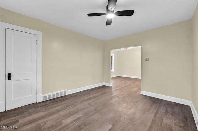 spare room featuring wood-type flooring and ceiling fan