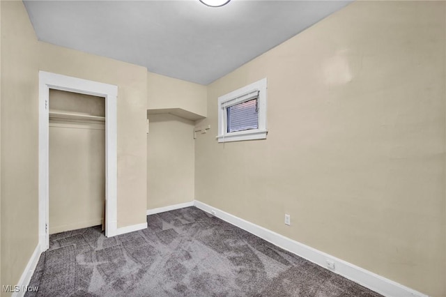 unfurnished bedroom featuring carpet flooring and a closet