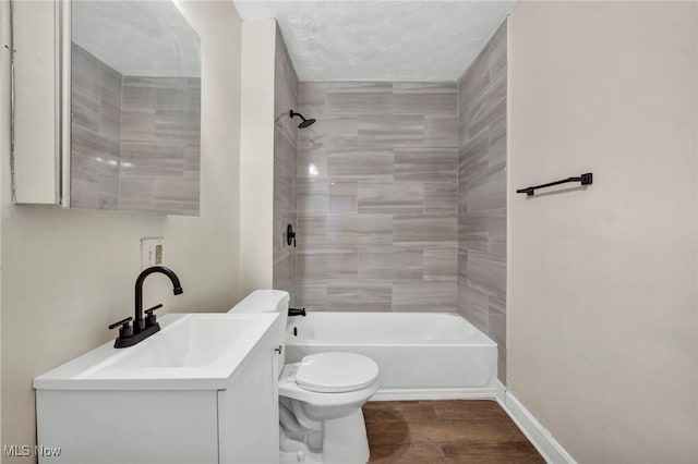 full bathroom with vanity, toilet, and tiled shower / bath combo